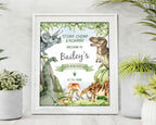 8 x 10 dinosaur party welcome sign in a white frame leaning on a grey wall with white pot full of greenery around it