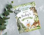 8 x 10 stomp chomp and roaarrr dinosaur party welcome sign with various dinosaurs and volcano graphics, laying on a grey stone background with a eucalyptus leaf