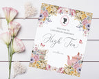 Small High tea Welcome Sign with floral design on a wooden surface with flowers and decorative hearts.