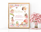 an 8 x 10 fairy tea party welcome sign in a gold frame leaning up against a white wall next to a vase of pink flowers