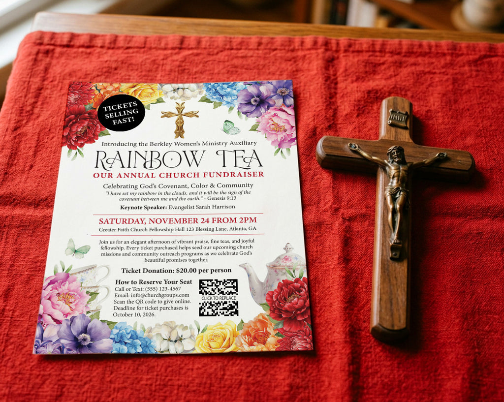 a red table cloth with a rainbow tea advertising flyer laying on it next to a wooden crucifix