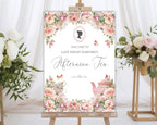 elegant pink flower sign for an afternoon tea event with cameo design and teapot illustration, placed on an easel next to flowers.