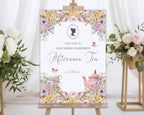 elegant welcome sign for an afternoon tea event with floral design, regency cameo and teacup illustration on an easel next to flowers