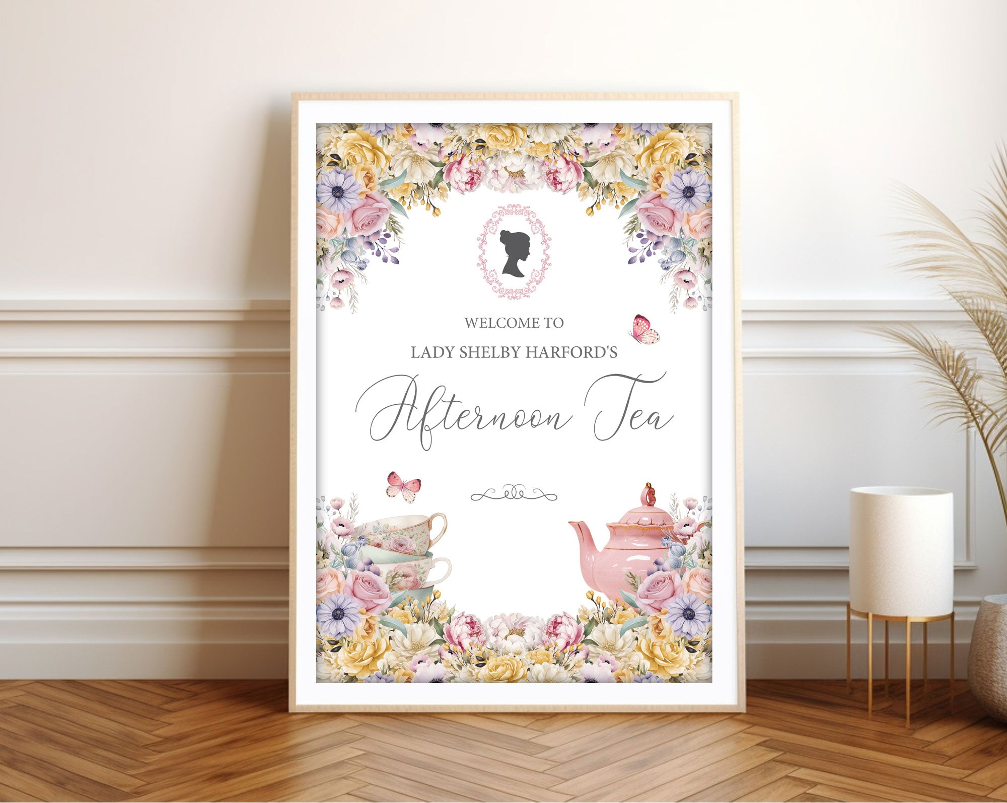 A1 pastel welcome sign  for an afternoon tea event with cameo, butterflies and teapot, framed  and leaning against a white wall