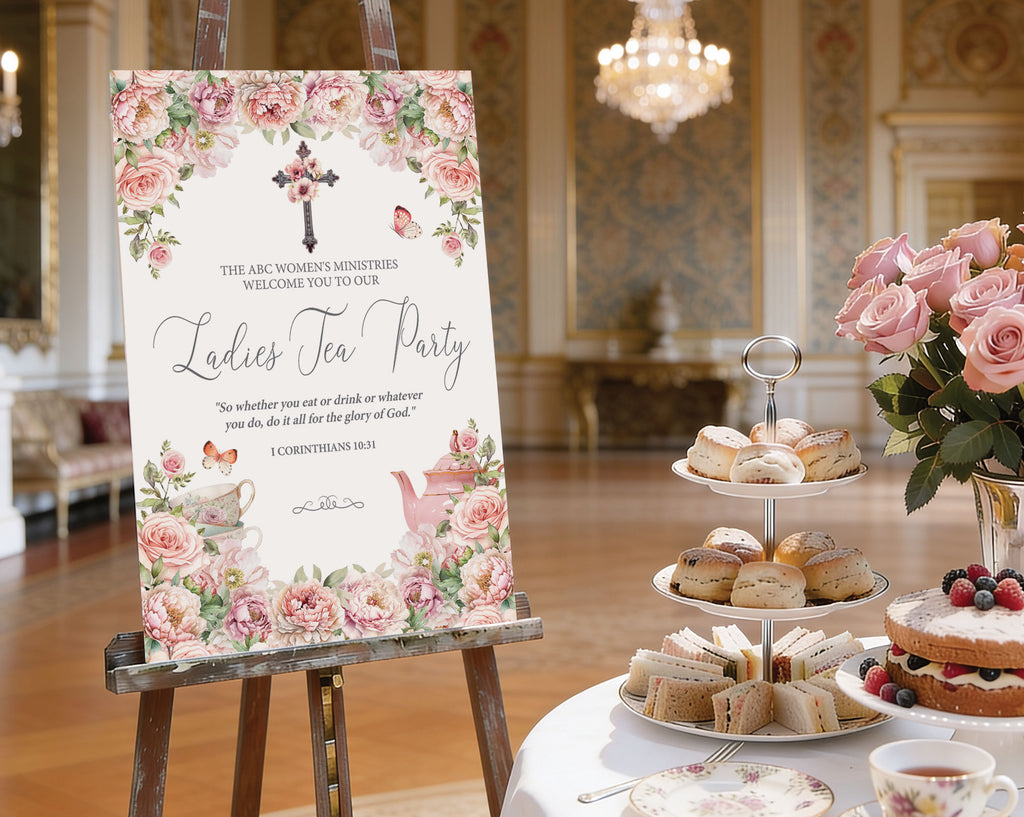 A2 ladies tea party welcome sign with christian flower cross, blush pink florals and teapot, on a wooden easel next to a round white tea table set with a tiered stand with sandwiches and cakes, pink flowers in a vase and a elegant room in the background