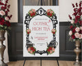 Elegant moody gothic high tea A1 sign with ornate black frame, gothic teapot, regency style cameo sitting on a black easel with red and pink roses at the side