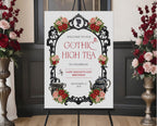 Elegant moody gothic high tea A1 sign with ornate black frame, gothic teapot, regency style cameo sitting on a black easel with red and pink roses at the side