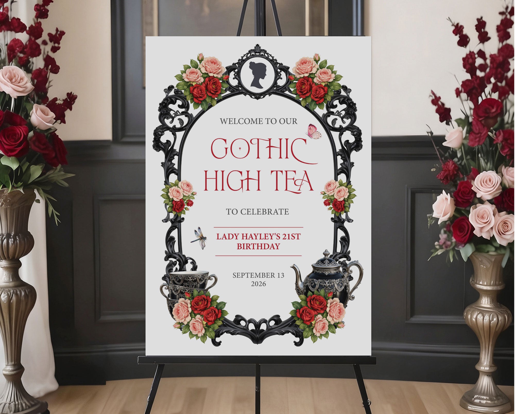Elegant moody gothic high tea A1 sign with ornate black frame, gothic teapot, regency style cameo sitting on a black easel with red and pink roses at the side