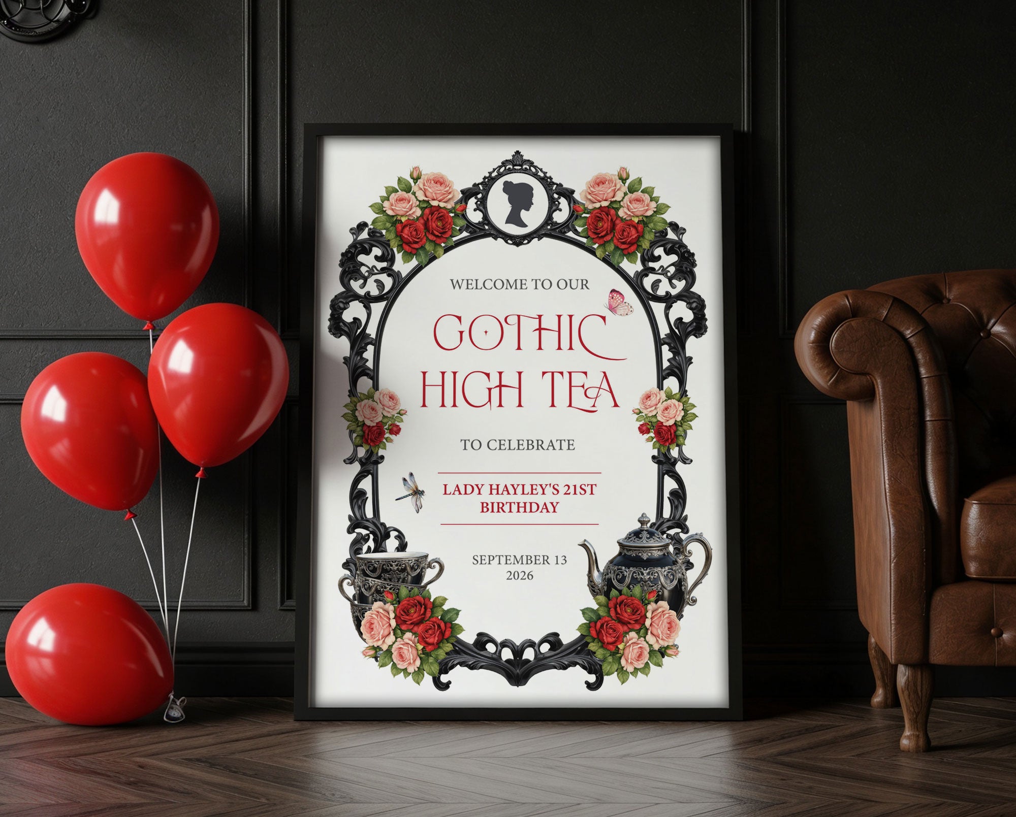 victorian gothic high tea party sign in a frame leaning up against a black wall next to some red balloons