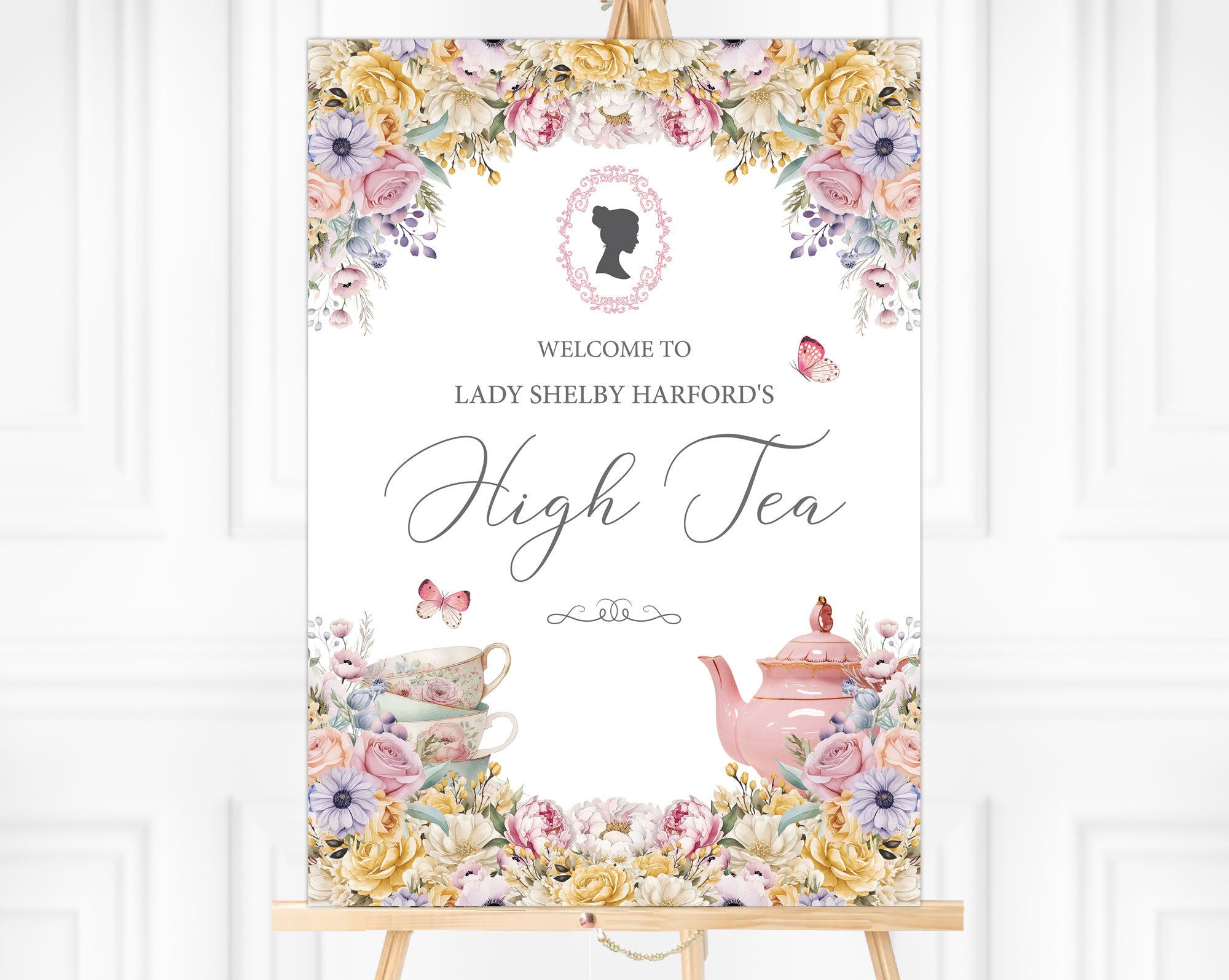 High Tea welcome sign on an easel with lady cameo, pink teapot and butterflies