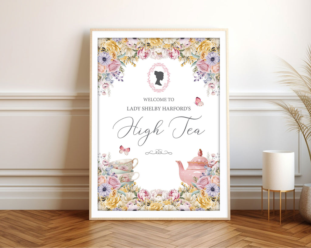 Framed welcome sign with pastel flowers, pink cameo, butterflies and teapot leaning up against a wall