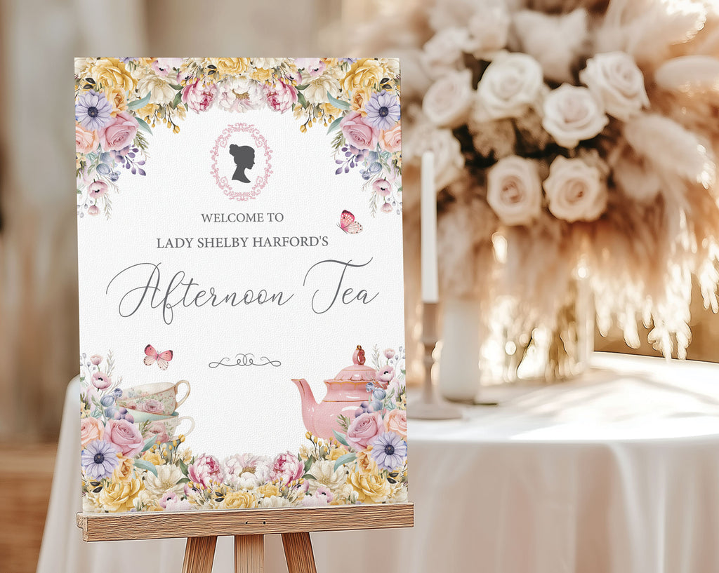 pretty pastel welcome sign for an afternoon tea event with cameo and teapot on an easel next to some cream flowers