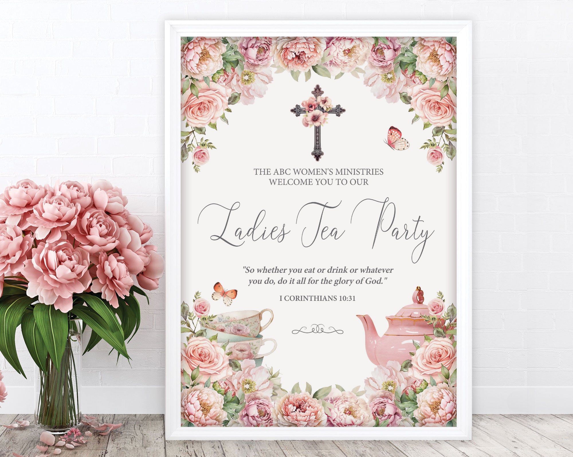 an A2 elegant blush pink flower ladies tea party welcome sign in a white frame leaning up against a white wall next to some pink flowers in a vase