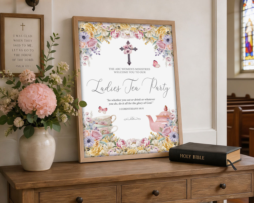 A3 Church Ladies Tea Welcome Sign in a white frame with Pastel flowers, Christian Cross and Teapot leaning up against a wall next to some greenery in vases