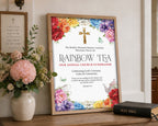 a bright A3 rainbow tea sign in a wooden frame leaning up against a church wall next to some flowers in a vase and a bible