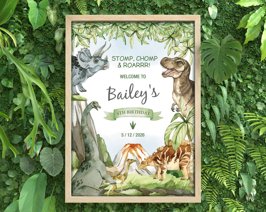 lots of dense greenery with a framed A3 dinosaur party welcome sign in a wooden frame laying on it