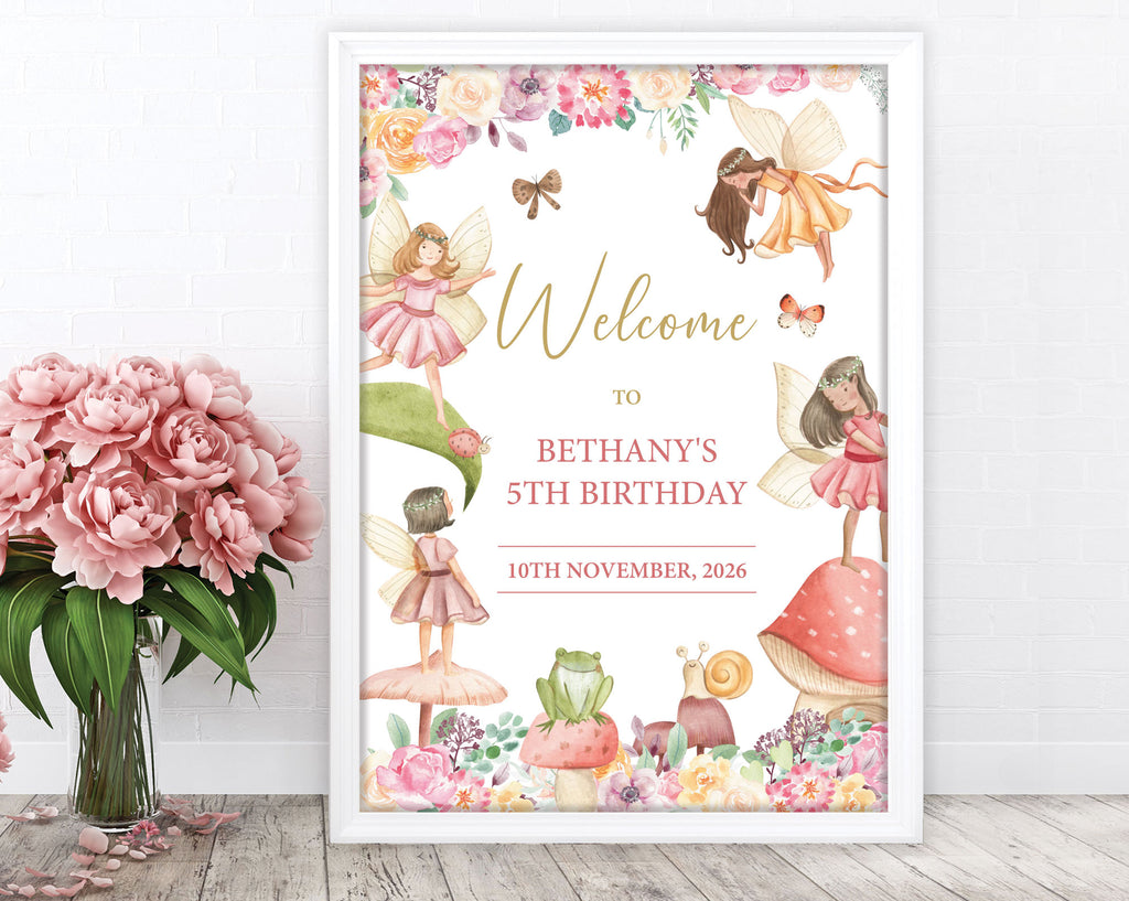 fairy garden tea party sign in a white frame leaning up against a white wall next to a vase of pink flowers