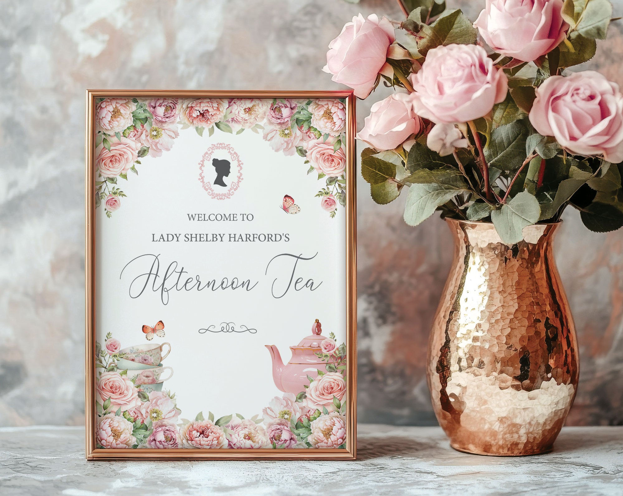 pretty Framed small bridgerton-inspired welcome sign for an afternoon tea event next to pink roses and a copper vase.