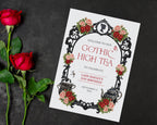 A4 red black and pink gothic high tea welcome sign laying on a black background next to some red rose stems