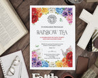 A printed 4 page A4 folded fundraiser program for a Rainbow Tea Church event is displayed in a styled flat-lay on a dark wooden table surrounded by an open Bible, glasses, a notebook, a cross, and other decorative items.