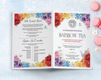 An open printed fundraiser program booklet for a Rainbow Tea, showing the front and back, laid flat on a light blue textured surface with pink macarons nearby. The booklet has colorful floral borders, teapot, cups and butterfly graphics.
