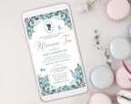 Phone displaying an afternoon tea invitation with floral design on a table with macarons.