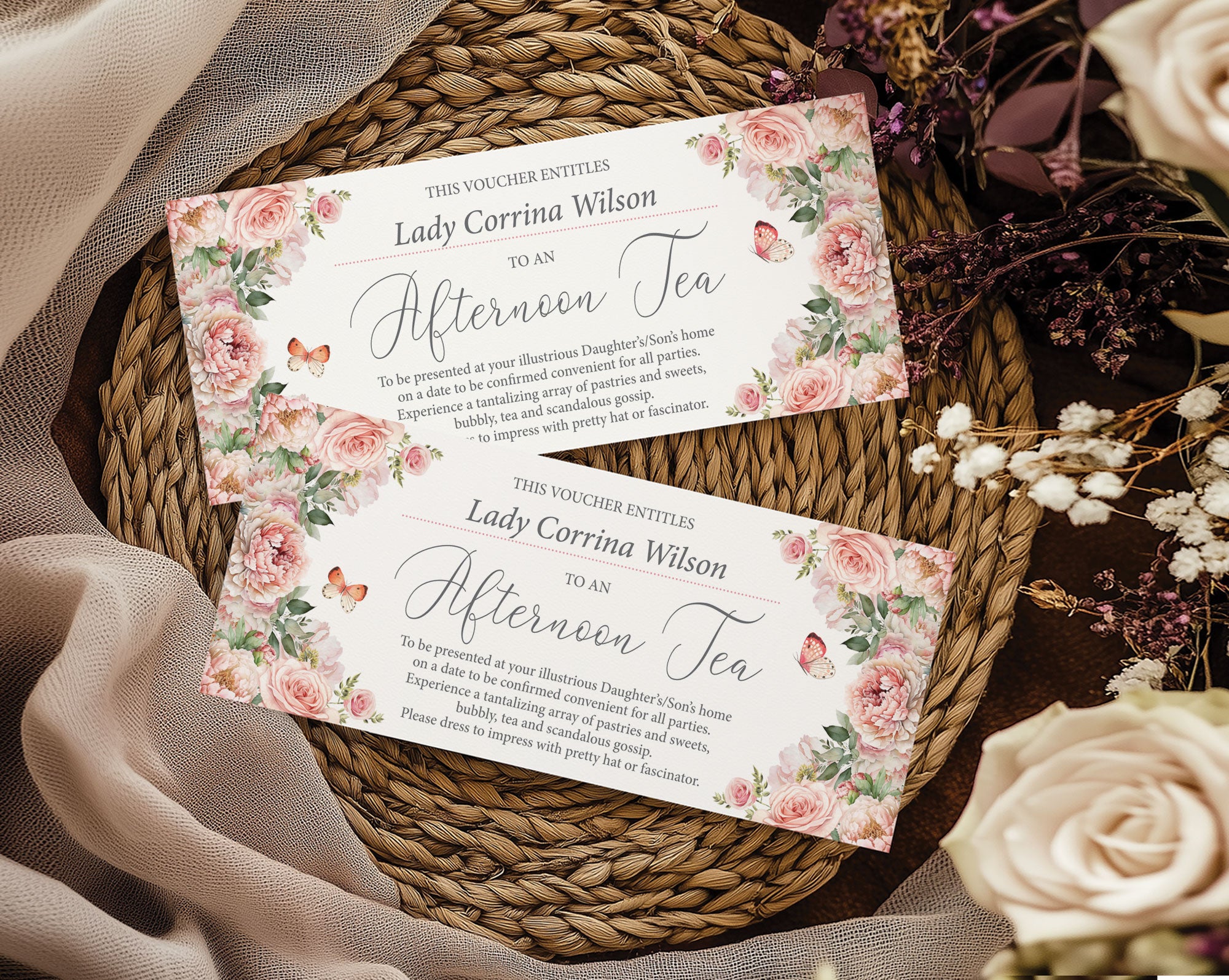 Two pink floral-themed vouchers on a woven mat with flowers around