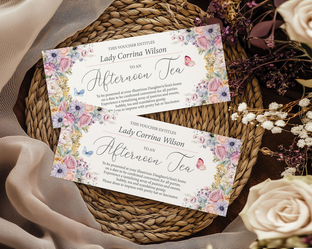 Two pastel flower and butterfly afternoon tea vouchers on a woven mat with flowers.