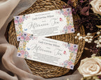 Two pastel flower and butterfly afternoon tea vouchers on a woven mat with flowers.