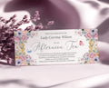 elegant pastel flower voucher for an afternoon tea with butterflies and text, leaning up against some dried flowers on a silk pink cloth