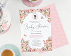 a blush pink flower baby shower invitation showing the front and the pink pattern back, laying on a white background next to a pastel tea service