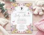 a pastel flower baby shower tea invitation with cameo and teapot, laying on a wooden background next to a white teddy bear, some baby blankets and eucalyptus