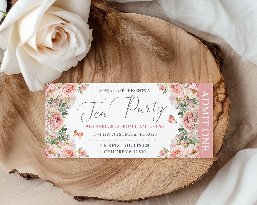 Pretty pink Tea party ticket with floral design on a wooden surface with white roses.