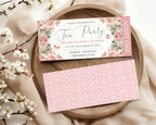 Blush pink Tea party event ticket with floral design on a wooden plate with cherry blossoms.