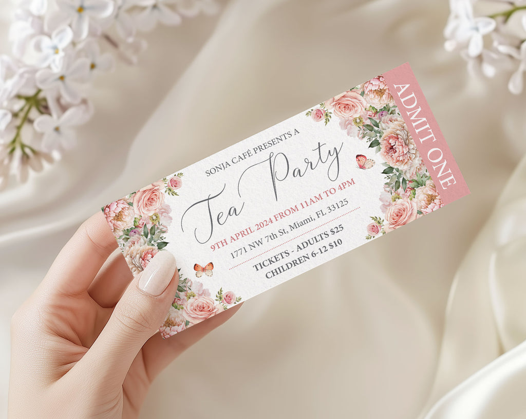 Pink ticket for a tea party, featuring floral designs and a hand holding it against a soft background.