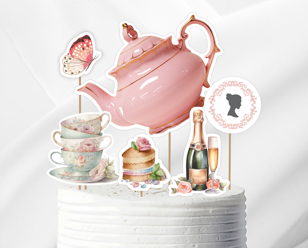 Decorative cake toppers with pink teapot, cups, cake, and champagne bottle on a white background