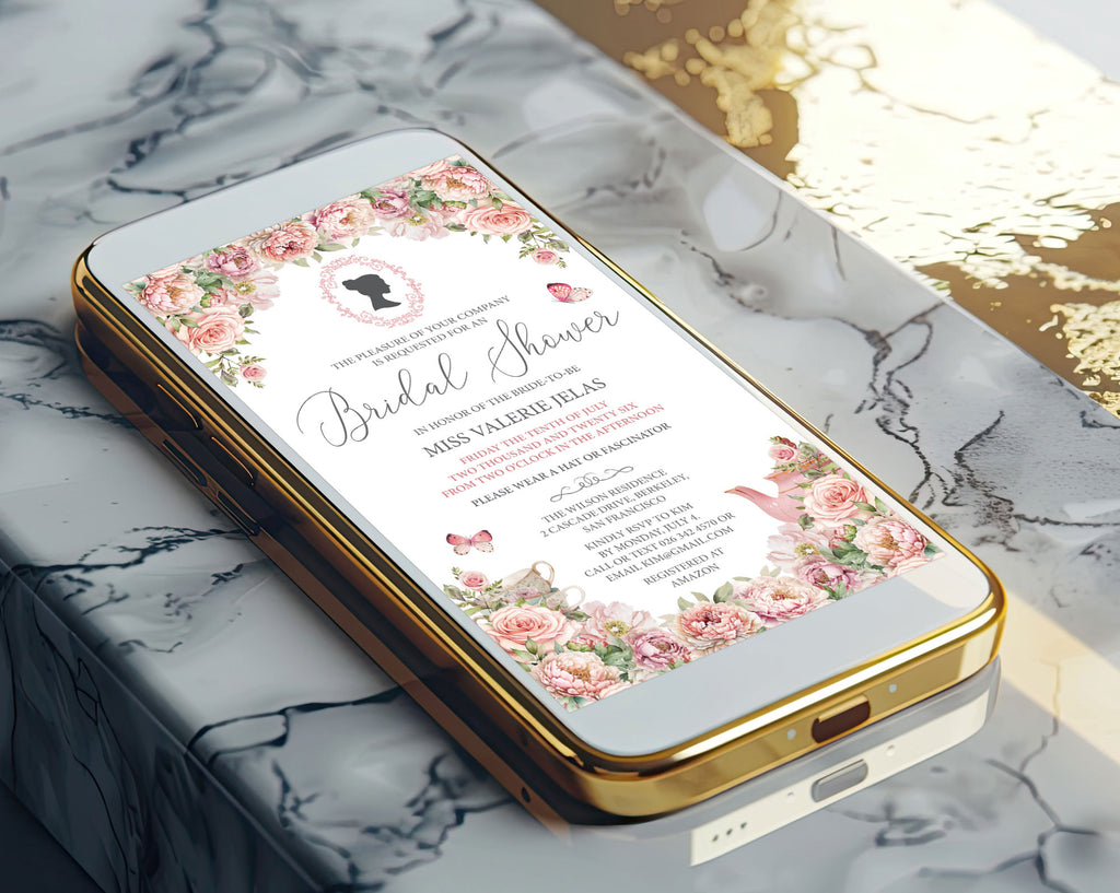 A gold mobile phone showing a pretty blush pink bridal shower victorian style invitation on the screen laying on a marble surface