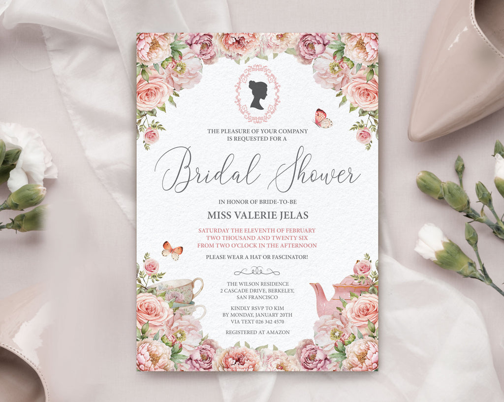 Bridal shower invitation with floral design on a white surface next to white carnations and a beige court shoe
