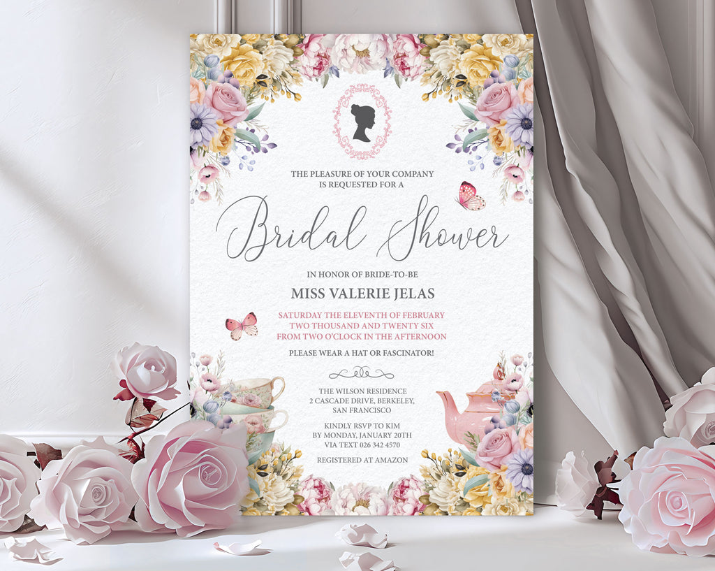 pastel flower bridal shower invitation with cameo leaning up against a grey curtain next to pink roses