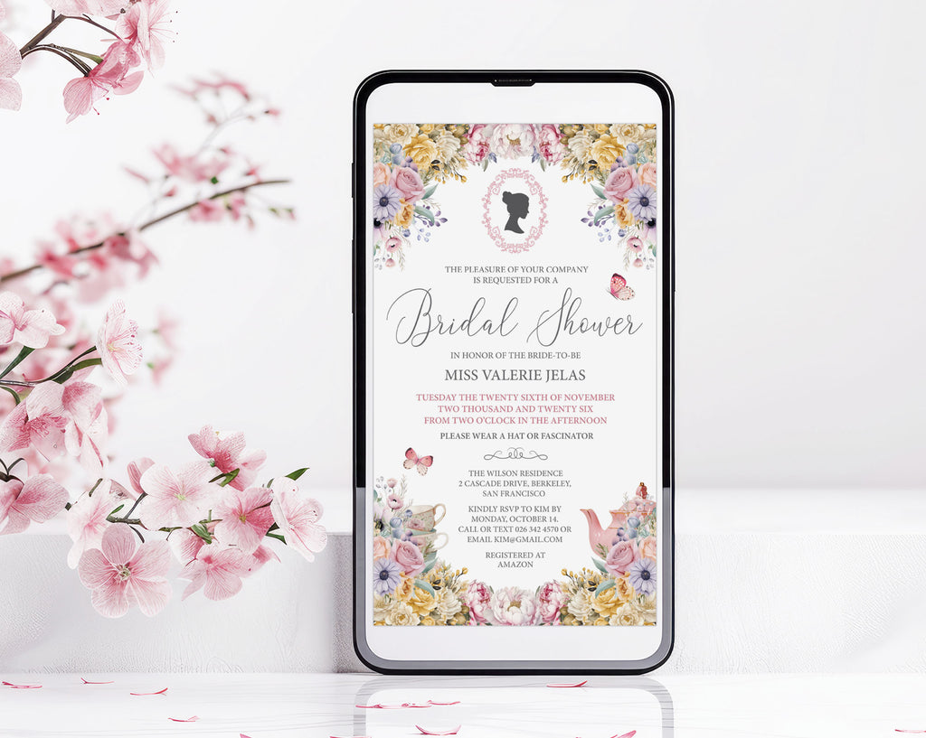 A smartphone centered on a white surface, displaying a regency style floral bridal shower invitation design with pink cherry blossom branches around it.