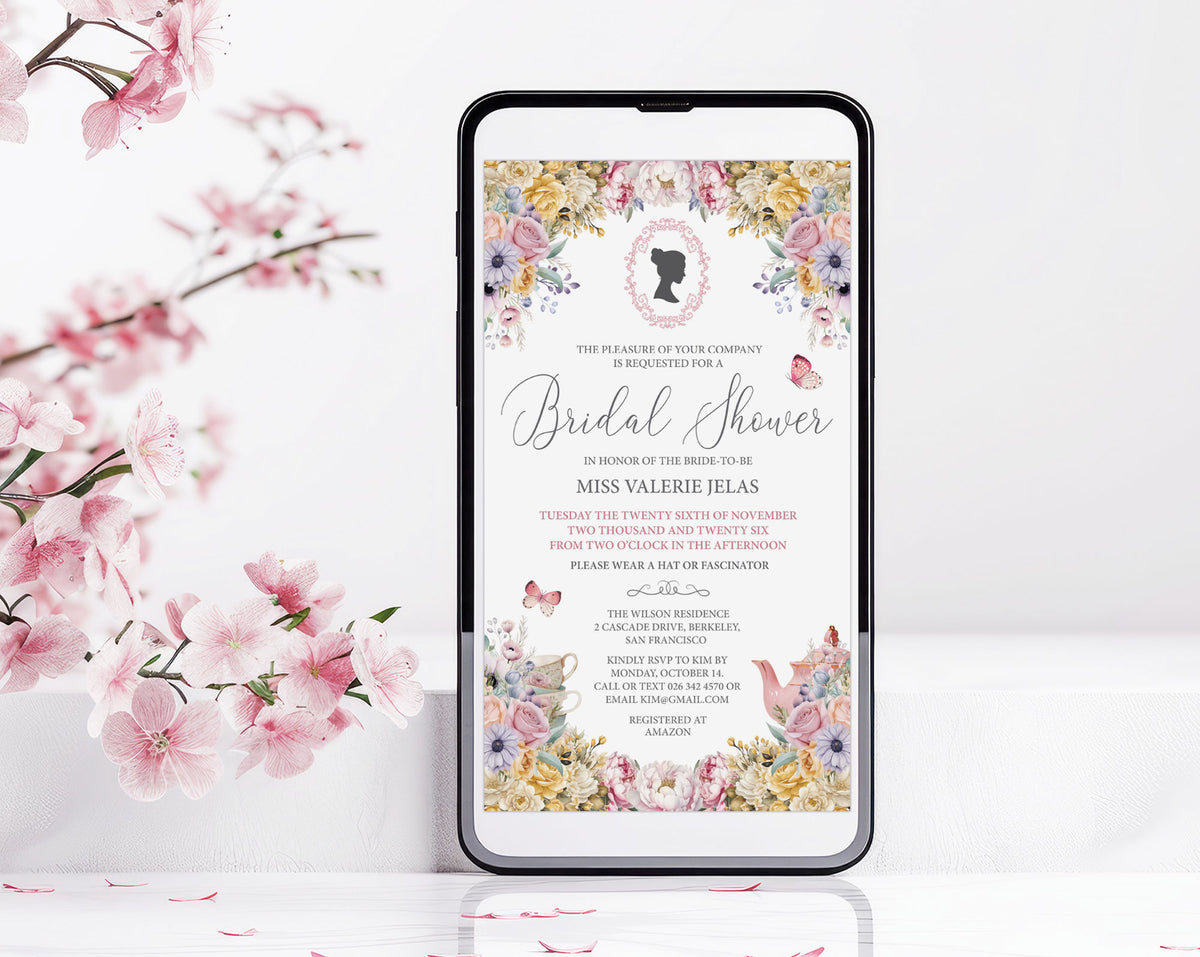 A smartphone centered on a white surface, displaying a regency style floral bridal shower invitation design with pink cherry blossom branches around it.