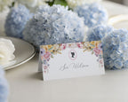 Regency style pastel name card with blue hydrangeas on a table