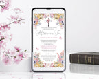 Phone displaying an religious afternoon tea invitation with floral design, surrounded by pink flowers and bible