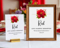 a 5 x 7 table card and a 8 x 10 sign both with red flower and scripture for a Church Rainbow Tea, sitting on a table with red napkins and curtains in the background