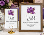 a 5 x 7 table card and a 8 x 10 framed sign with violet colored flower and scripture, on a white table with purple and white tea setting in the background