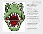 A printed dinosaur head design shown in two pieces on a white card, with text on the right explaining how to print and cut it out. The design features a green dinosaur face with a red mouth interior and white teeth.