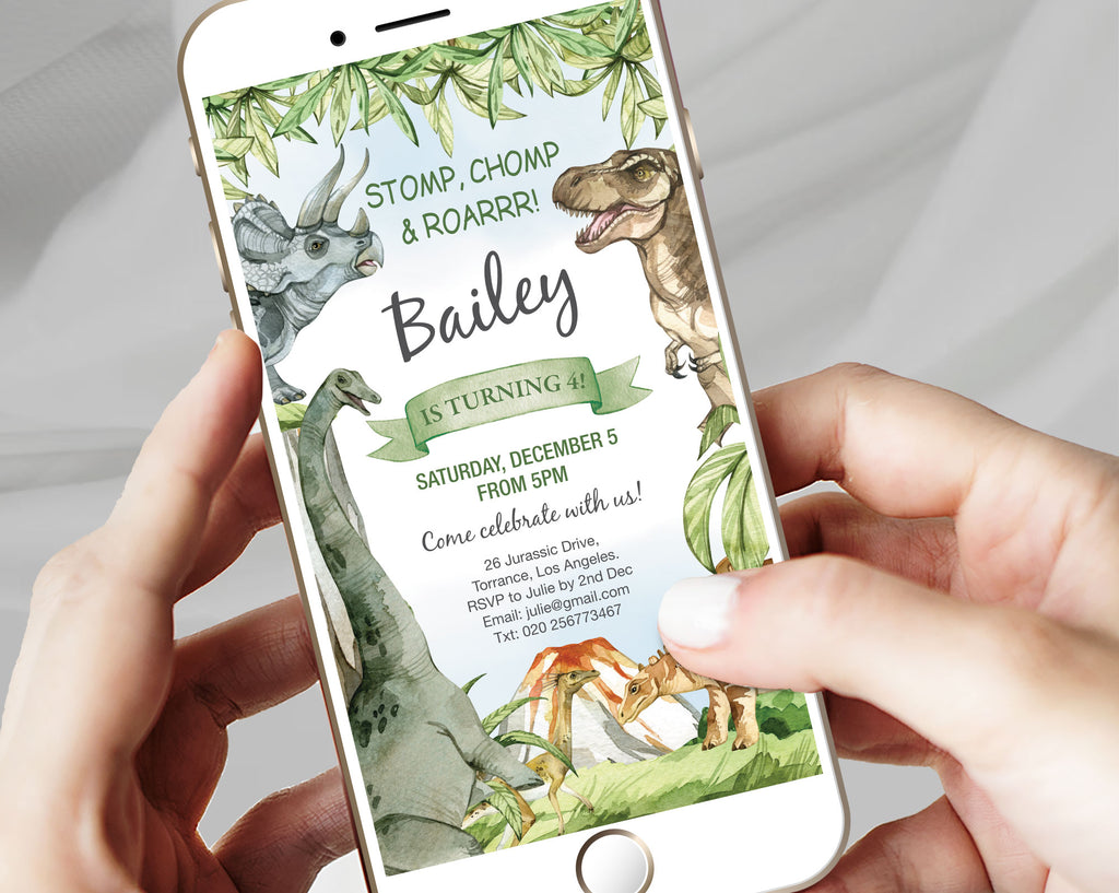 two hands holding a white mobile phone with a kids dinosaur party invitation showing on the screen with a grey background
