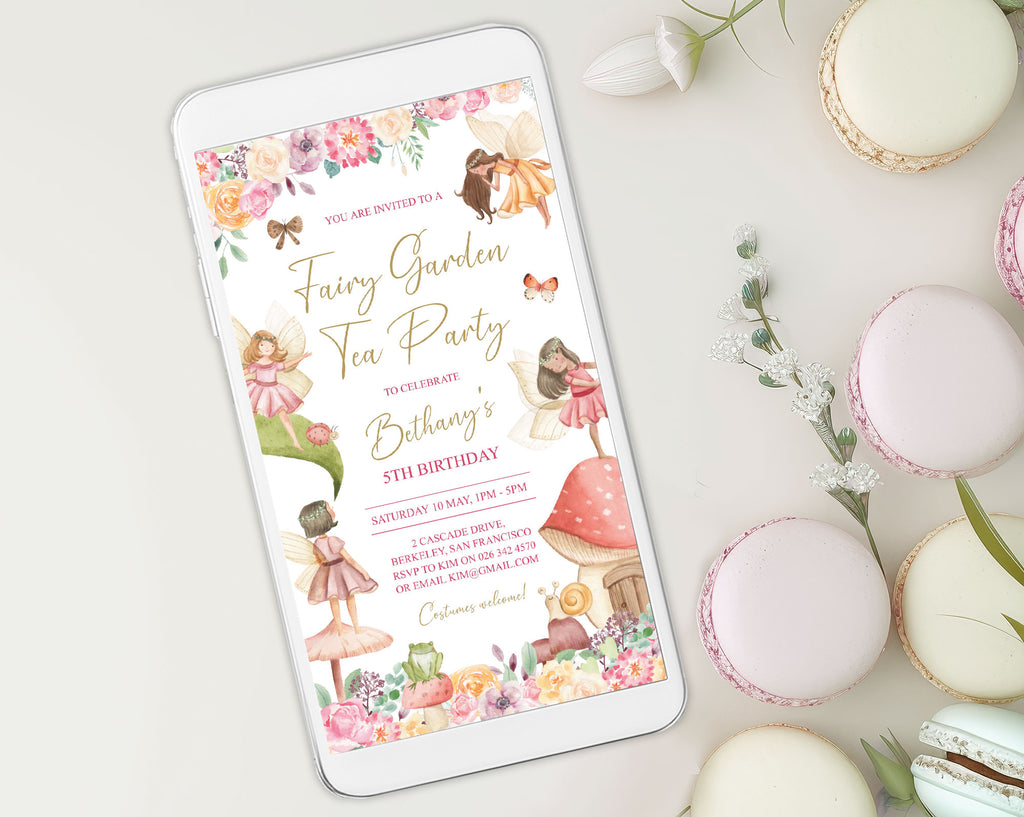 pretty pastel macarons laying next to a white mobile phone that is showing a fairy garden tea party