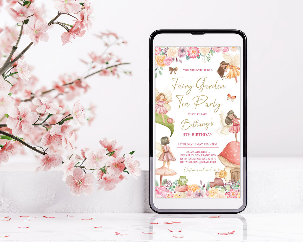 pretty fairy tea invitation showing on the screen of mobile phone that is leaning up against a small wall next to some cherry blossoms