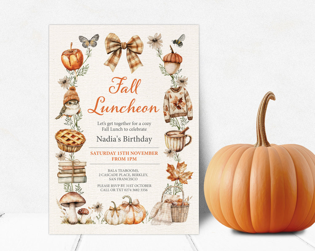 A fall-themed birthday invitation card displayed next to a whole orange pumpkin on a white wood surface. The invitation features an autumn border with illustrations of pumpkins, leaves, a bird, a mug, and text reading 'Fall Luncheon' and 'Nadia's Birthday'.